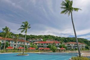 a view of a resort with palm trees and a pool at Beachfront Reunions @ Canyon Cove in Nasugbu