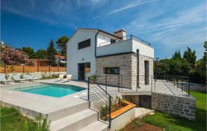 a villa with a swimming pool and a house at Villa Stella Mare in Premantura