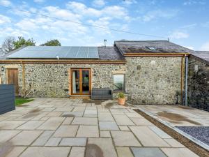 a stone house with solar panels on the roof at Bwlchygwynt in Llanwrda