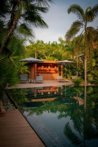 a house with a swimming pool and palm trees at Angkor Grace Residence & Wellness Resort in Siem Reap