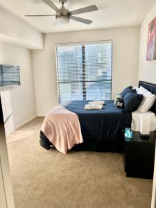 a bedroom with a bed with a ceiling fan at Modern comfort at The Domain Austin ,Texas in Austin