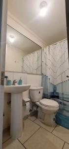 a bathroom with a toilet and a sink at departamento Arica verano 2 habitaciones in Arica