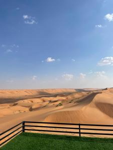 a fence in the middle of the desert at Moon Light Camp in Bidiyah