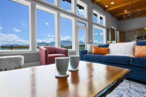 a living room with a couch and a table at Modern Cabin near Smoky Mountain National Park in Gatlinburg