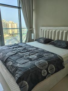 a bedroom with a bed with a large window at 7 Palm Jumeirah in Dubai