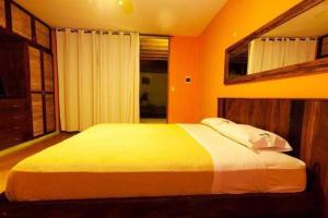 a bedroom with a large bed in an orange room at Kites Mancora in Máncora +36 photos
