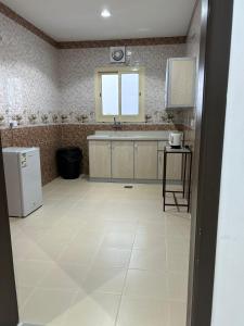 a kitchen with a sink and a refrigerator at ليالي الراحة للوحدات السكنية in Taif