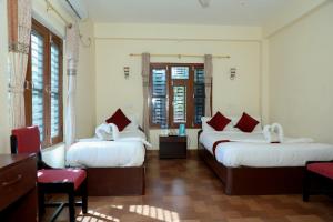 Postel nebo postele na pokoji v ubytování Hotel Vista Chitwan