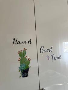 a picture of a plant on a wall with the words have a good time at Suite Emilia in SantʼIlario dʼEnza