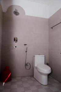 a bathroom with a toilet and a shower stall at Hotel Vista Chitwan in Sauraha