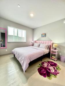 a bedroom with a large bed with purple flowers on the floor at Brand new Apartment with Extra Sofa Bed, air conditioning, 15 mins to Alki Beach and Downtown Seattle and 19 mins to SeaTac Airport in Seattle