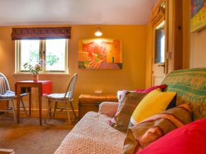 a living room with a couch and a table at Owls Nest in Stradbroke