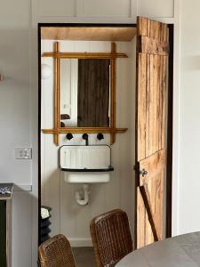 a bathroom with a sink and a mirror at Log Box Red Hill in Red Hill South