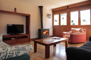 a living room with a couch and a fireplace at Apartamentos Irati Garralda in Garralda