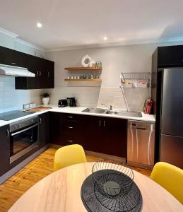 A kitchen or kitchenette at Cozy Urban Chinatown Escape Adelaide CBD - Free parking