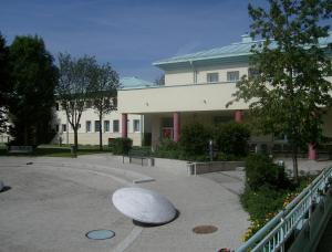 a large building with a large metal object in front of it at Hostel Obertrum in Obertrum am See