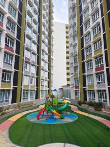 a playground in an apartment complex with tall buildings at Wyattcamp @ mahkota valley in Kuantan