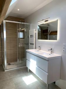 a bathroom with a sink and a glass shower at Sol i Munt Cerdanya in Enveitg