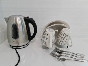 a coffee maker and utensils on a counter at Sky Tree Studio Apartment at Bukit Indah, Johor in Johor Bahru