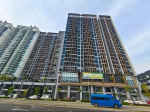 a blue van parked in front of a large building at Sky Tree Studio Apartment at Bukit Indah, Johor in Johor Bahru