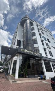 a building with a sign that reads entrance hotel at Extreme Boutique Hotel in Kluang