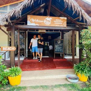 two men standing in the doorway of a restaurant at A casa di Giorgia lodge Nosy be Andilana in Nosy Be