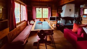 a living room with a table and a couch at Chalet im Gus - Flumserberge & Walensee in Oberterzen