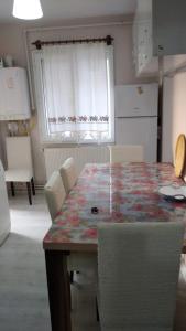 a kitchen with a table and chairs and a window at Sky IZMIR Center Big Suit Home in İzmir