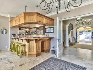 a kitchen with a large island in a house at Devonport House - Constantia in Cape Town