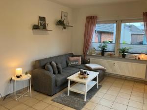 a living room with a couch and a table at Nordseebude in Husum