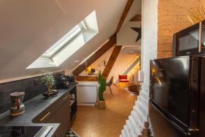 a kitchen with a skylight in a loft at un Nid en Ville -Amiens Centre ville avec Parking in Amiens