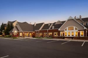 a large building with a parking lot in front of it at Residence Inn Minneapolis St. Paul/Roseville in Roseville