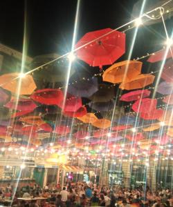 a bunch of umbrellas hanging from a ceiling at Fikus APT relax Castello Ursino in Catania