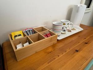 a wooden crate with cups and plates on a table at Rose Cottage 