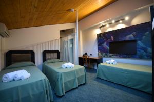 Postel nebo postele na pokoji v ubytování Hotel Celis
