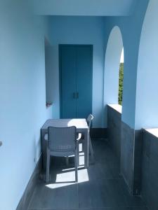 a blue room with a table and a chair at Luxury,2 level penthouse in Tsakhkadzor in Tsaghkadzor