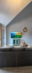 a living room with a couch and a flat screen tv at Luxury,2 level penthouse in Tsakhkadzor in Tsaghkadzor