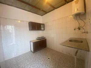 a bathroom with a sink and a tiled wall at شاليه خاص in Riyadh