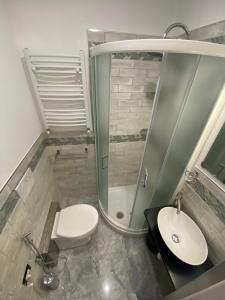 a bathroom with a toilet and a sink and a shower at Rolando 20B in Genoa +37 photos