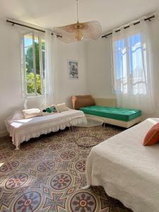 Cette chambre comprend 2 lits et un canapé. dans l'établissement Charmant haut de villa T3, à Saint-Cyr-sur-Mer