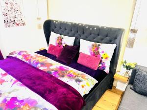 a bed with pink and purple sheets and pillows at Natal Gian in Ischgl