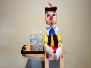 a lego man sitting on a table with water bottles at Dynasty Hotel & Resort Osaka in Osaka