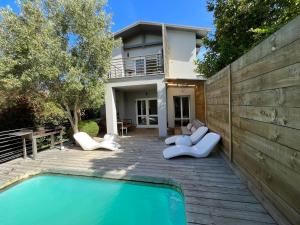 a house with a swimming pool in front of a house at Baha Sanctuary Villa - 2 Bedroom Pool Villa in Plettenberg Bay