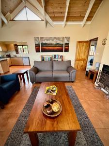a living room with a couch and a table at Touchstone Cottage in Hilton