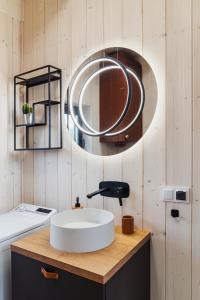 a bathroom with a white sink and a mirror at Garczovka - domki, jacuzzi, sauna in Garcz