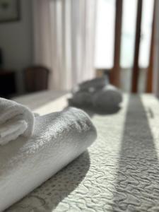 a group of towels on a bed in a room at SUITE APARTMENT TAORMINA in Taormina
