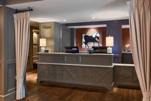 a hair salon with a checkout counter and curtains at Ambassador Hotel Oklahoma City, Autograph Collection in Oklahoma City