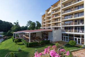 an exterior view of a large apartment building at Madara Park Hotel - All Inclusive in Golden Sands