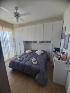 a bedroom with a large bed and a desk at Il Paradiso del Relax private room with bathroom Parking in Sanremo