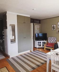 a living room with a refrigerator and a tv at Aslak Apartment in Saariselka